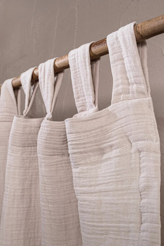 Cream tab loops on bamboo rod closeup. Handwoven 2-layer muslin cotton curtain, Denizli, OEKO-TEX. Vivamaison.
