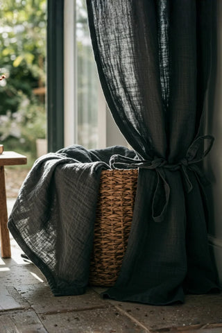 Dark panel tied with fabric strap, basket. Handwoven 2-layer muslin cotton curtain, Denizli, OEKO-TEX. Vivamaison.
