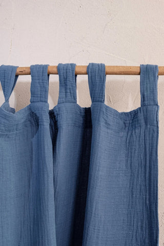 Blue tab loops on wooden rod, texture visible. Handwoven 2-layer muslin cotton curtain, Denizli, OEKO-TEX. Vivamaison.