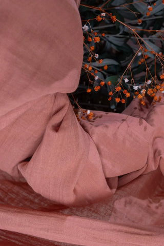 Coral gauze texture closeup with dried flowers. Handwoven 2-layer muslin cotton curtain, Denizli, OEKO-TEX. Vivamaison.