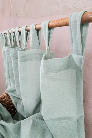 Angled close-up of mint tab top header. Handwoven 2-layer muslin cotton curtain, Denizli, OEKO-TEX. Vivamaison.