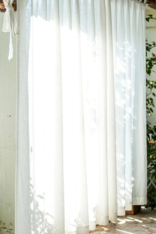 Backlit white gathered curtains with knotted tie. Handwoven 2-layer muslin cotton curtain, Denizli, OEKO-TEX. Vivamaison.