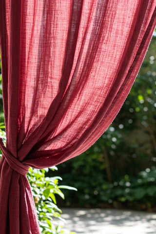 Backlit curtain gathered with tieback in garden. Handwoven 2-layer muslin cotton curtain, Denizli, OEKO-TEX. Vivamaison.