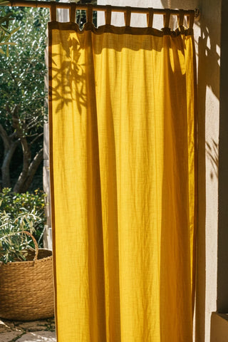 Full mustard tab top panel backlit garden. Handwoven 2-layer muslin cotton curtain, Denizli, OEKO-TEX. Vivamaison.