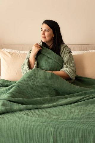Dark Green handwoven 4-layer muslin Turkish cotton bedspread folded flat lay. Long-staple Denizli, OEKO-TEX. Vivamaison.