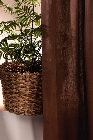 Backlit brown stonewashed cotton curtain fabric close-up. Handwoven in Denizli, OEKO-TEX. Vivamaison.